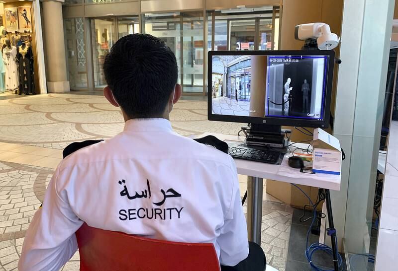 DUBAI, UNITED ARAB EMIRATES , April 28 – 2020 :- Security guard monitoring the temperature of the visitors to prevent the spread of the coronavirus at one of the entrance of the Ibn Battuta Mall in Dubai. Authorities ease the restriction for the residents in Dubai. (Pawan Singh / The National) For News/Standalone/Online/Instagram/Stock