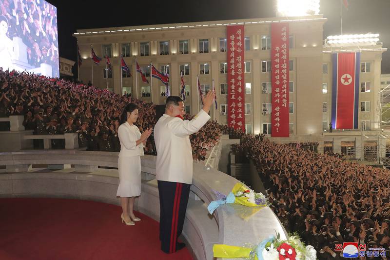 North Korean leader Kim Jong-un and his wife Ri Sol-ju acknowledge the audience during a military parade to mark the 90th anniversary of North Korea's army in Pyongyang. AP