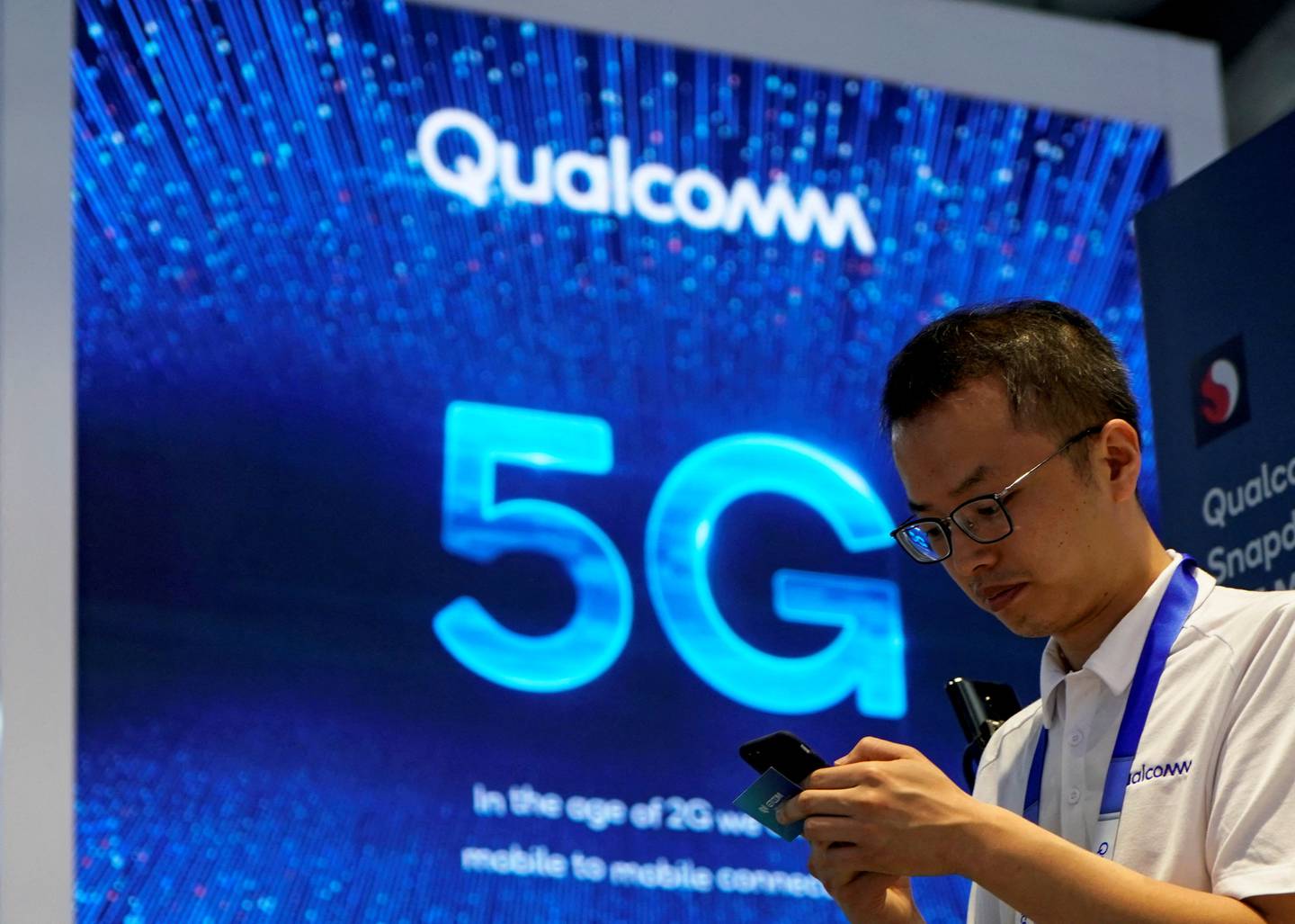 Qualcomm and 5G signs at Mobile World Congress in Shanghai.  Reuters