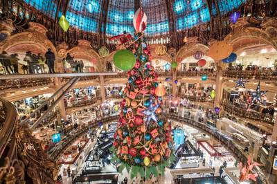 The traditional Christmas tree of the Galeries Lafayette department store stands under its great dome in Paris. French stores can reopen starting November 28 after several weeks of lockdown.  EPA