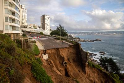 A road destroyed by a landslide after a water collector collapsed due to heavy rains in Valparaiso, Chile. AFP
