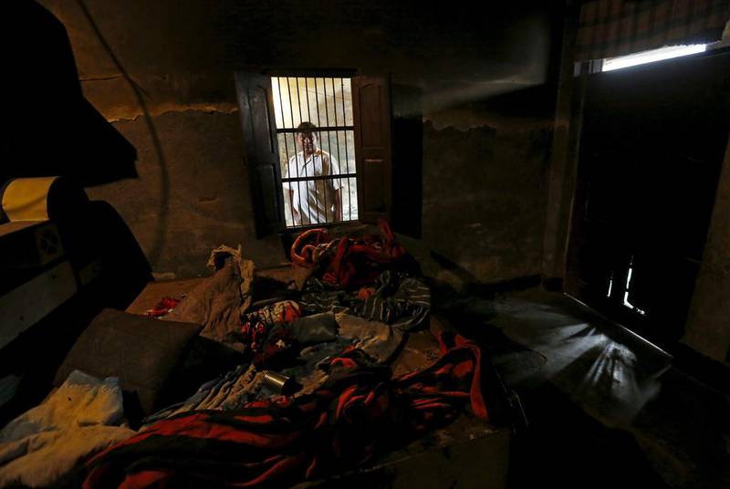 A man looks through a window into a room, which police said is the site where two children were burnt alive by a group of men, at the Sunpedh village in Ballabhgarh.  Adnan Abidi / Reuters