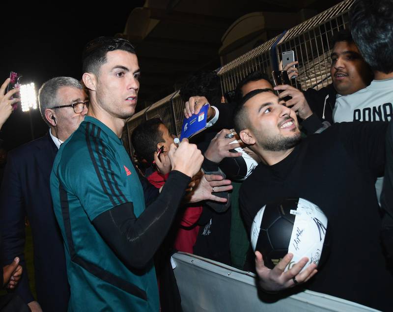Ronaldo signing autographs and taking selfies before the training session.Getty