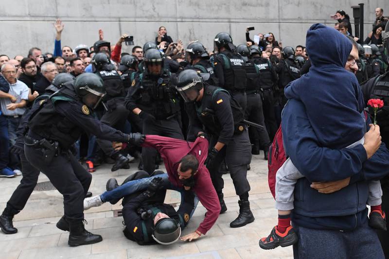 A man struggles with police as more than five million eligible voters are expected to visit polling stations for Catalonia's referendum on independence from Spain. David Ramos /Getty Images
