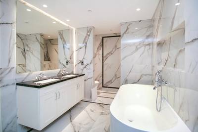 Streaky marble adorns the bathroom walls.