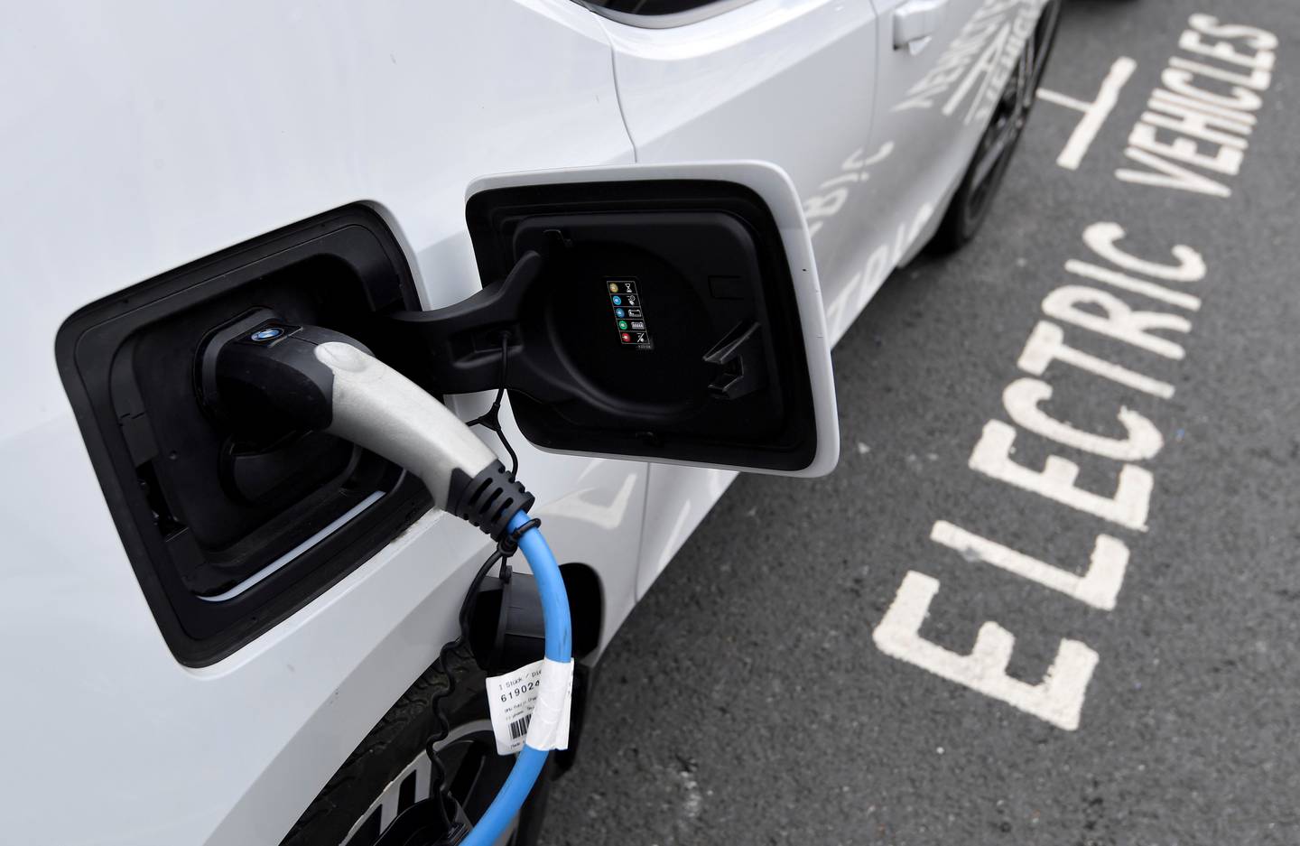 An electric car is charged at a roadside EV charge point in London. Photo: Reuters