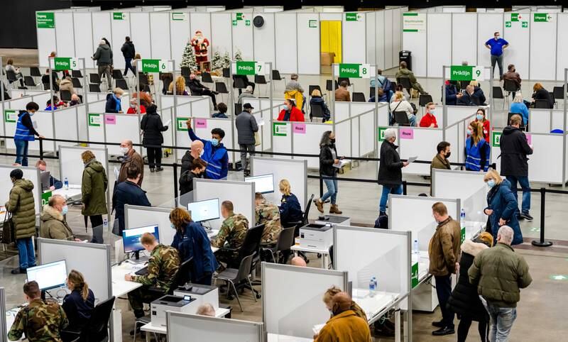 People attend their anti-Covid19 vaccination at the vaccination center in the Ahoy venue in Rotterdam, the Netherlands, 27 December 2021.  40 injection lines have been set up at the new location, where more than 90 hospital employees administer a jab. EPA