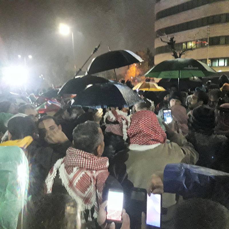 Jordanians in Amman brave torrential rain to protest against corruption and economic austerity on December 20, 2018. Taylor Luck