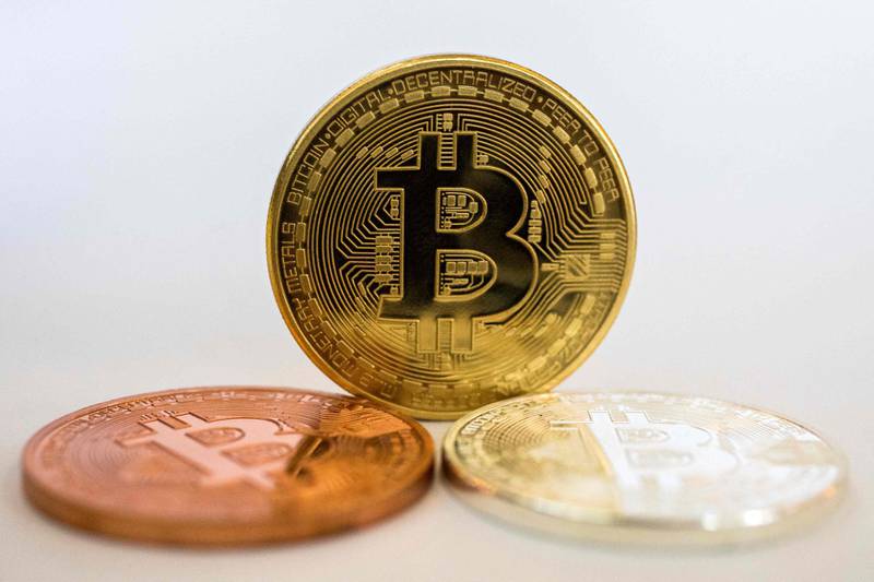 (FILES) In this file photo taken on February 06, 2018 A picture taken on February 6, 2018 shows a visual representation of the digital crypto-currency Bitcoin, at the "Bitcoin Change" shop in the Israeli city of Tel Aviv. Bitcoin briefly rose above $60,000 for the first time on March 13, 2021, as the world's most popular virtual currency continued its record-breaking run. / AFP / JACK GUEZ

