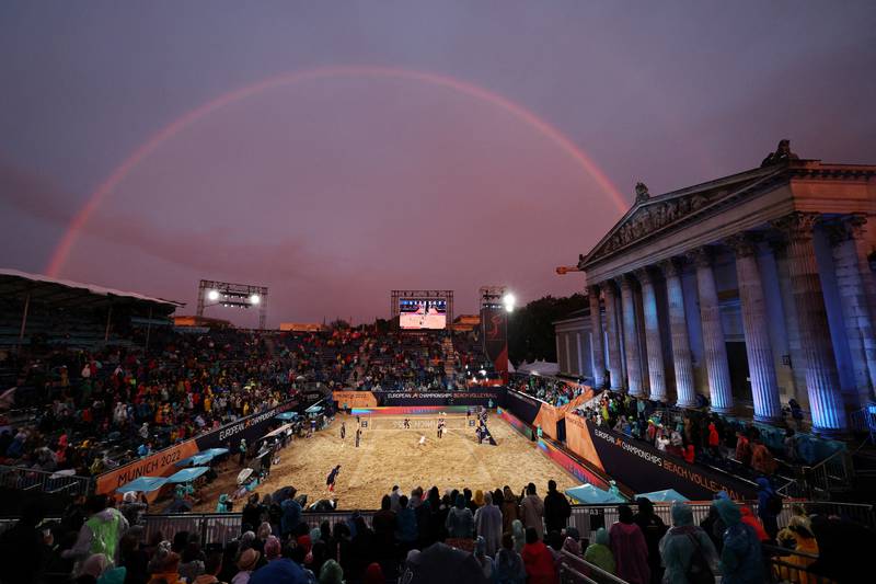 A rainbow frames the start of the women's gold medal beach volleyball match between Latvia and Switzerland at the 2022 European Championships in Munich, Germany. Reuters