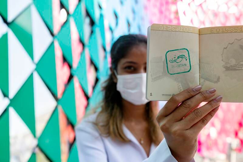 Leona Luiz from India gets her passport stamped by Sumaiya at the Pakistan pavilion on the first day of Expo 2020 Dubai. Chris Whiteoak / The National