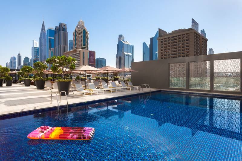 The outdoor pool comes with city skyline views.