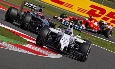 Finnish driver Valtteri Bottas of Williams, front, steers his car ahead of British driver Jenson Button of McLaren-Mercedes during the British Grand Prix at Silverstone on July 6, 2014.  Geoff Caddick / EPA