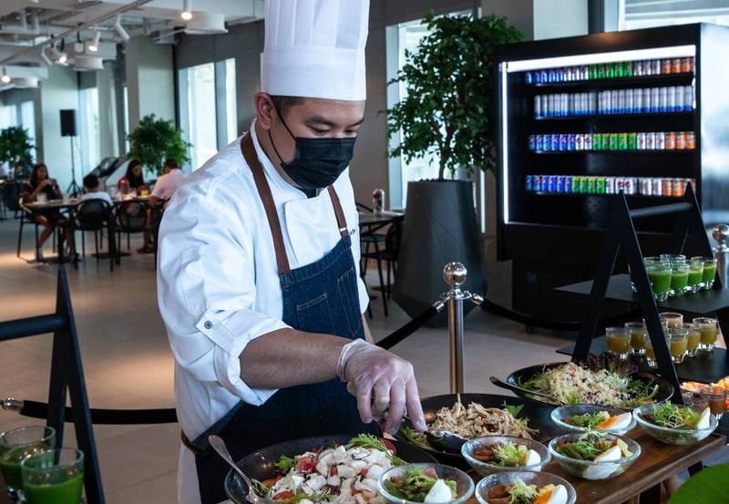 Chef Tristan prepares Friday brunch at the 2020 Club by Emaar at Expo 2020 Dubai. The staff serve guests at the stations