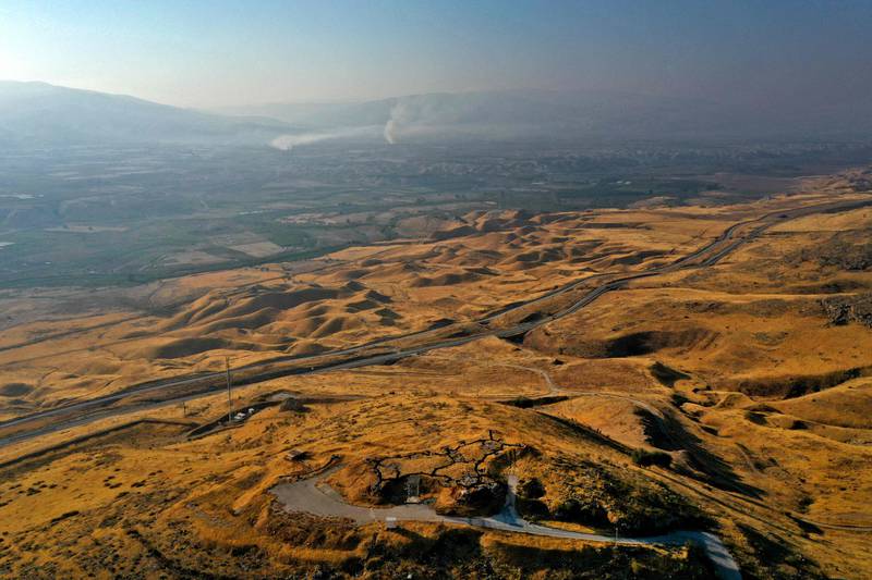 A picture taken on July 15, 2021, shows an abandoned Israeli army post in the Jordan Valley in the occupied West Bank near the border with Jordan (background).  AFP
