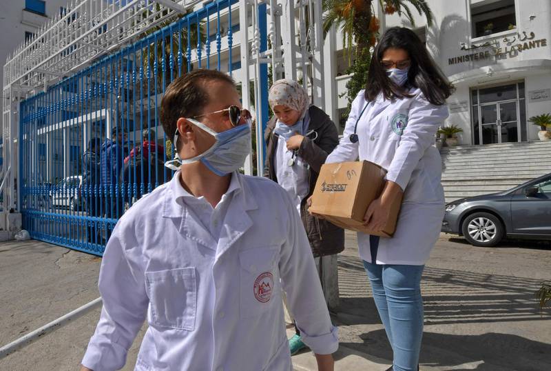 Emergency doctors and nurses, who have been trained to handle coronavirus disease cases, exit the Tunisian health ministry premises in the capital Tunis.  AFP