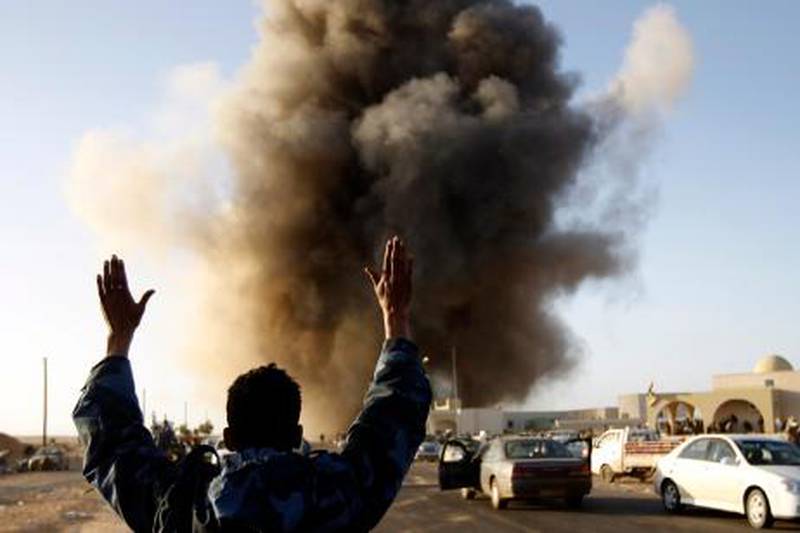 A rebel fighter reacts during an airstrike in Ras Lanuf, March 7, 2011.
 Government forces struck at rebels in Libya's east and were reported attacking a town near Tripoli on Monday as concern grew over civilian suffering and a growing refugee exodus. 
   REUTERS/Goran Tomasevic (LIBYA - Tags: POLITICS CIVIL UNREST IMAGES OF THE DAY) *** Local Caption ***  GOT09_LIBYA_0307_11.JPG