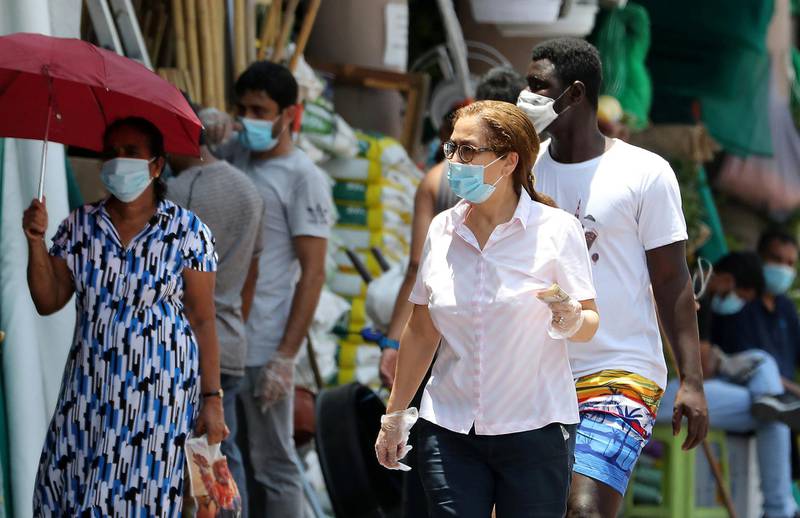 DUBAI, UNITED ARAB EMIRATES , June 11 – 2020 :- People wearing protective face mask during the hot and humid weather in Al Satwa area in Dubai. (Pawan Singh / The National) For News/Standalone/Online/Stock