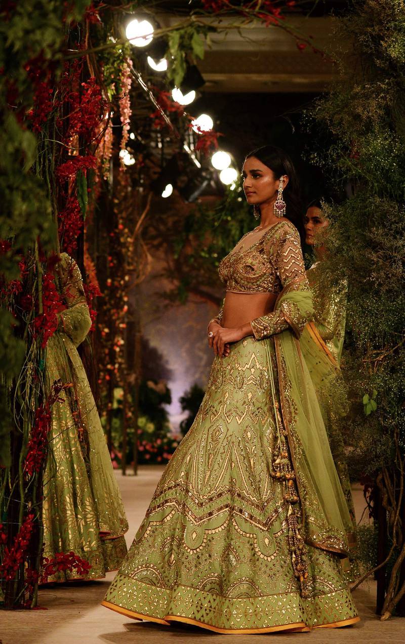 Reynu Taandon titled her collection Once Upon A Dream, and her lehengas and bridalwear came in shades of pale gold and mint, as in this look, as well as ivory, coral and pastel tones. AFP