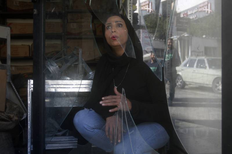 A woman at a shop damaged in Friday's explosion in Burj Shamali Palestinian refugee camp in Tyre, Lebanon. AP