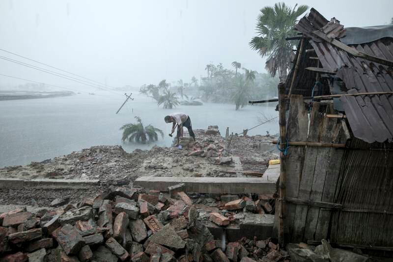 Winner of the Health in a Heating World category is 'Climate Cost' by Zakir Hossain Chowdhury. Three months after Cyclone Amphan hit Bangladesh, a man salvages anything still useful from the wreckage of his house.