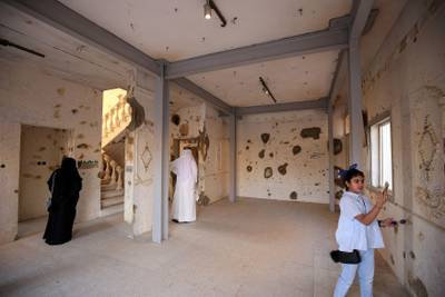 Kuwaitis visit the Al-Qurain Martyr's Museum on August 2, 2017, on the 27th anniversary of the 1990 Iraqi invasion of Kuwait.
The Al-Qurain Martyr's Museum is the home of a battle which lasted 10 hours between invading Iraqi troops and a group of Kuwaiti fighters during the Iraqi occupation of Kuwait. The battleground house has been converted to the Al-Qurain Martyr's Museum. / AFP PHOTO / Yasser Al-Zayyat
