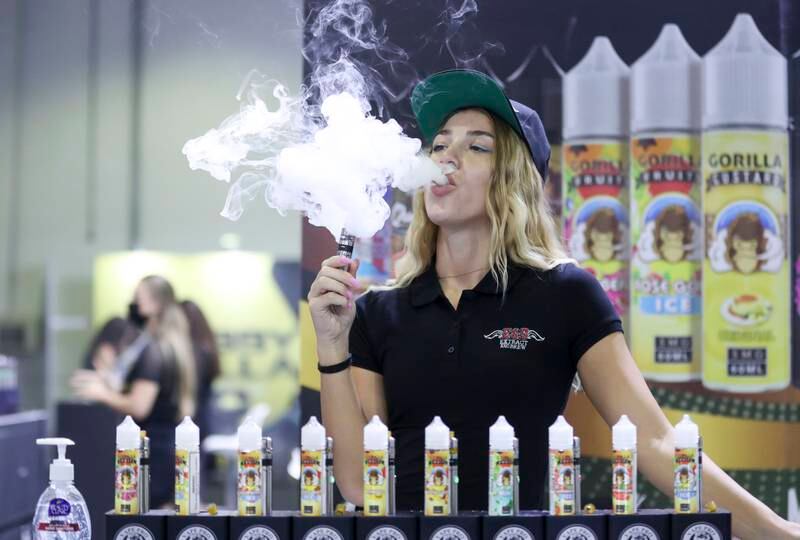 Exhibitors vape designs with their mouths at Dubai World Trade Centre. All Photos by Khushnum Bhandari / The National