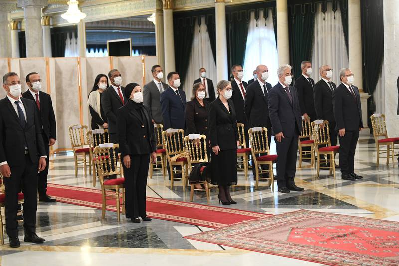 Members of Tunisia's new government, with face masks, stand during their swearing-in ceremony in Tunis. Photo: Tunisian Presidency via Reuters