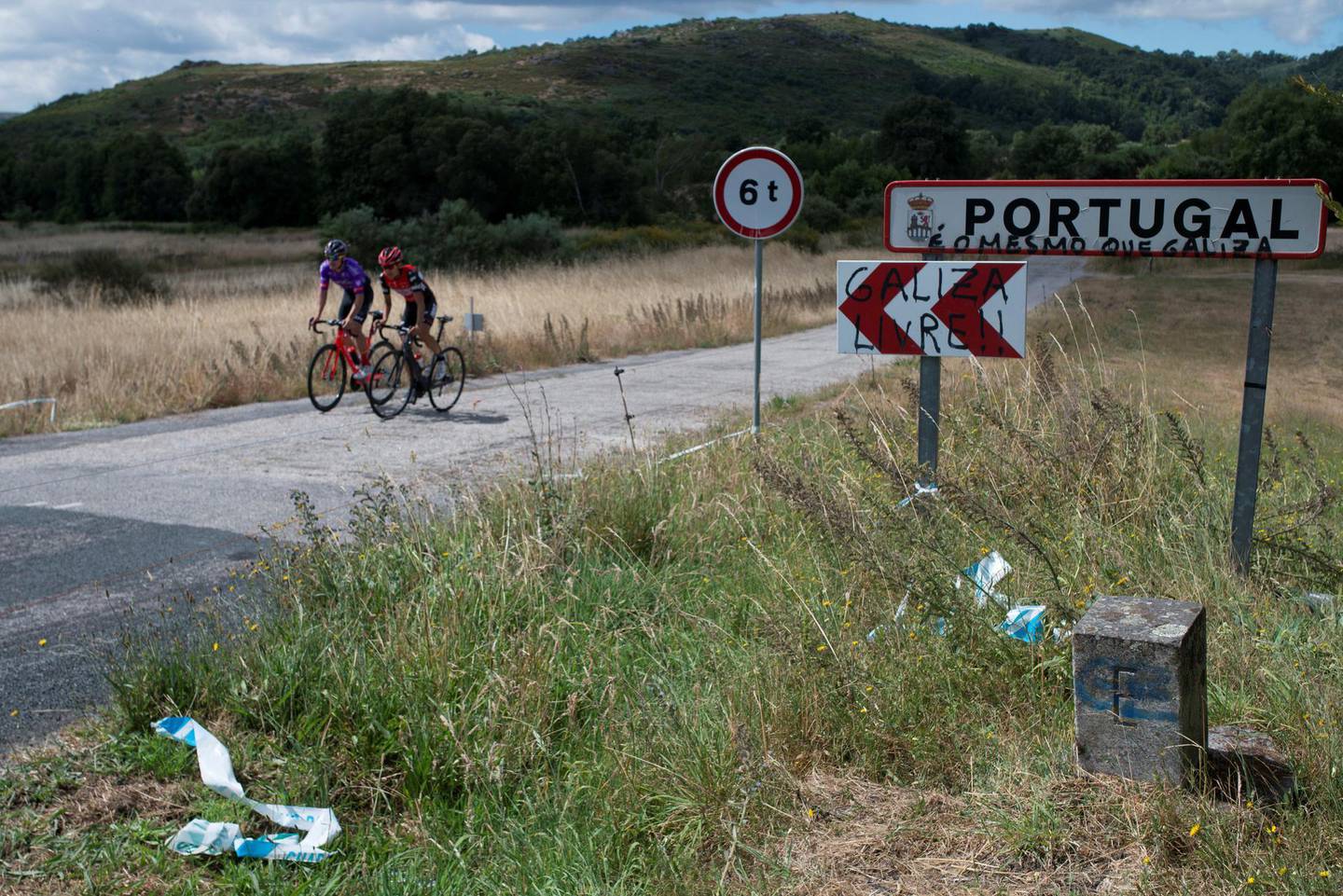 epa08520590 Cyclists cross the border between Spain and Portugal after the official ceremony of borders reopening between two countries in A Xironda, northwestern Spain, 01 July 2020. The borders are opened three and half months after its closing due to the coronavirus disease (COVID-19) pandemic  EPA/BRAIS LORENZO