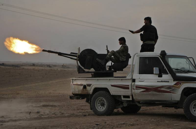 Turkish-backed Syrian fighters fire a truck mounted heavy gun near the town of Tukhar, north of Syria's northern city of Manbij, as Turkey and it's allies continues their assault on Kurdish-held border towns in northeastern Syria. Turkey wants to create a roughly 30-kilometre (20-mile) buffer zone along its border to keep Kurdish forces at bay and also to send back some of the 3.6 million Syrian refugees it hosts. AFP