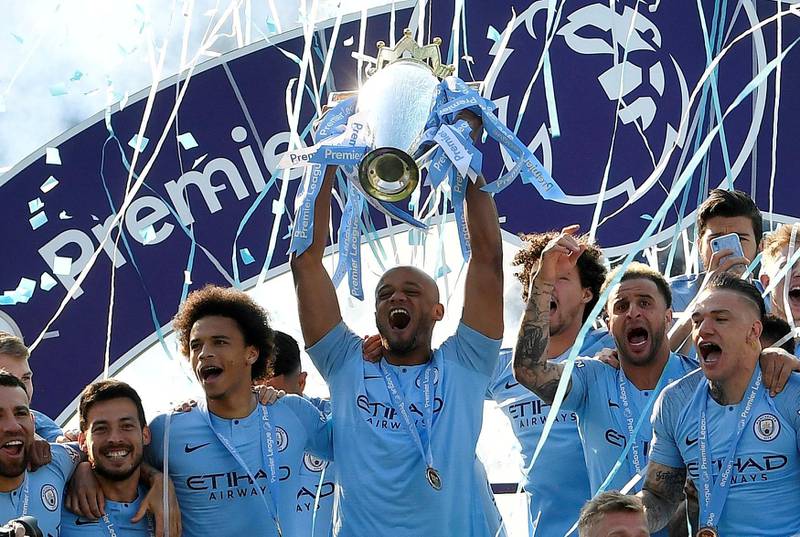 FILE PHOTO: Soccer Football - Premier League - Brighton & Hove Albion v Manchester City - The American Express Community Stadium, Brighton, Britain - May 12, 2019    Manchester City's Vincent Kompany lifts the trophy as they celebrate winning the Premier League                 REUTERS/Toby Melville/File photo  EDITORIAL USE ONLY. No use with unauthorized audio, video, data, fixture lists, club/league logos or "live" services. Online in-match use limited to 75 images, no video emulation. No use in betting, games or single club/league/player publications.  Please contact your account representative for further details.