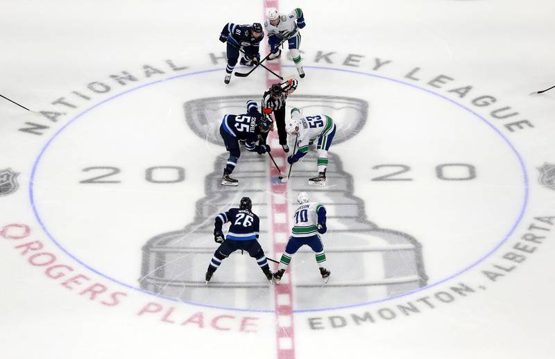 Winnipeg Jets' Mark Scheifele and Bo Horvat of the Vancouver Canucks in the opening face-off in an exhibition game prior to the 2020 NHL Stanley Cup Play-offs at Rogers Place in Edmonton on Wednesday, July 29. AFP