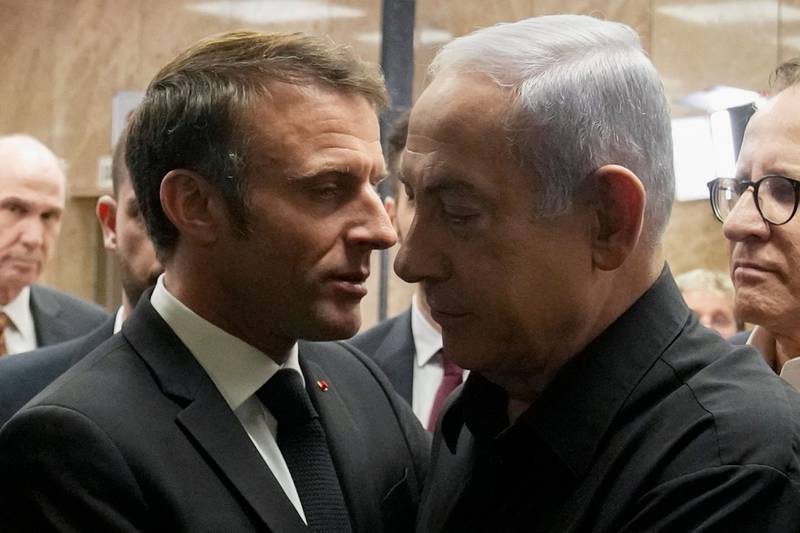 Israeli Prime Minister Benjamin Netanyahu embraces French President Emmanuel Macron after their joint press conference in Jerusalem on Tuesday. AFP
