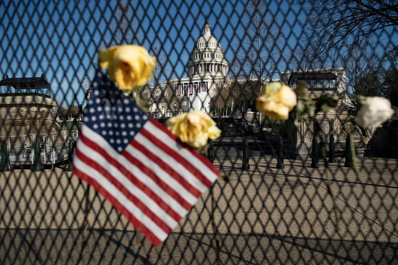 Flowers on a fence, a week after a pro-Trump mob broke into and took over the Capitol, in memory of slain Capitol Police Officer Brian Sicknick, in Washington, January 14, 2021. AFP