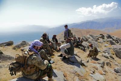 An Afghan resistance movement and anti-Taliban uprising forces rest as they patrol on a hilltop in Panjshir province on September 1,2021. Panjshir remains the last major holdout of anti-Taliban forces led by Ahmad Massoud, son of the famed mujahideen leader Ahmed Shah Massoud. AFP