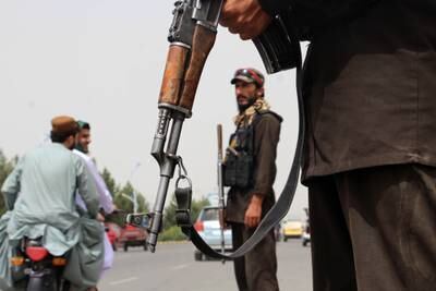 Taliban security officers check motorcyclists in Kandahar, Afghanistan, on July 30. EPA