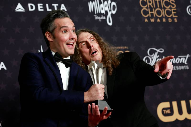 Director Eric Appel, left, and singer Weird Al Yankovic with the award for Best Movie Made for Television for Weird: The Al Yankovic Story. AFP
