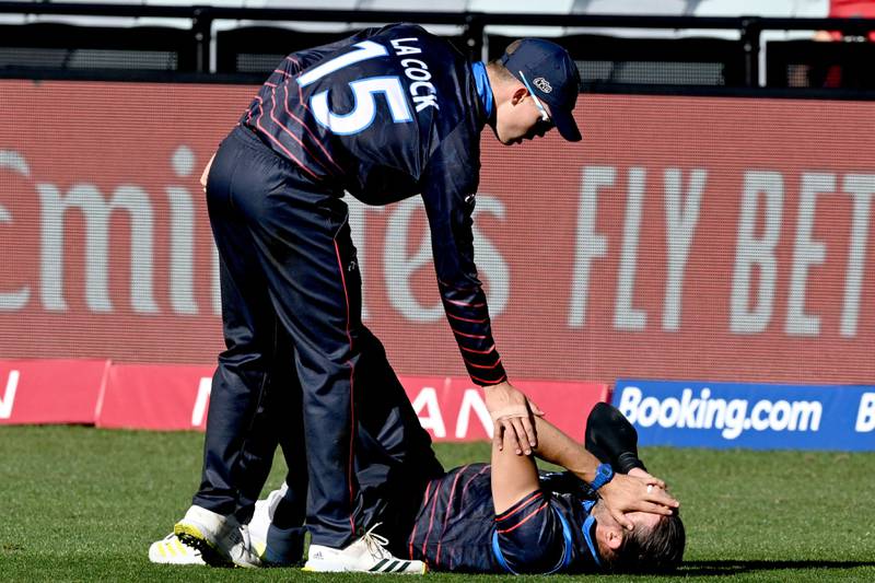 Namibia's Divan la Cock, left, checks on David Wiese as he falls over in an attempt to field the bal. AFP