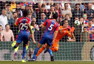 Crystal Palace goalkeeper Vicente Guaita saves a headed chance from Huddersfield Town's Chris Lowe from close range. PA via AP