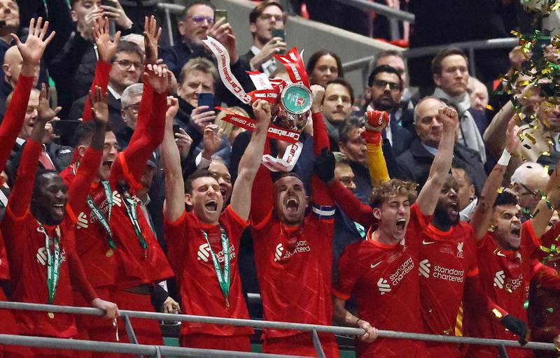 Liverpool's Jordan Henderson lifts the League Cup trophy after defeating Chelsea in a penalty shoot-out at Wembley Stadium on Sunday, February  27, 2022. Reuters