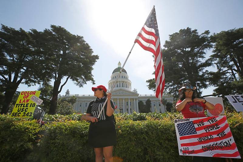 Protesters calling for Gov. Gavin Newsom to ease stay-at-home order caused by the coronavirus, gather at the Capitol in Sacramento, California, USA. AP Photo