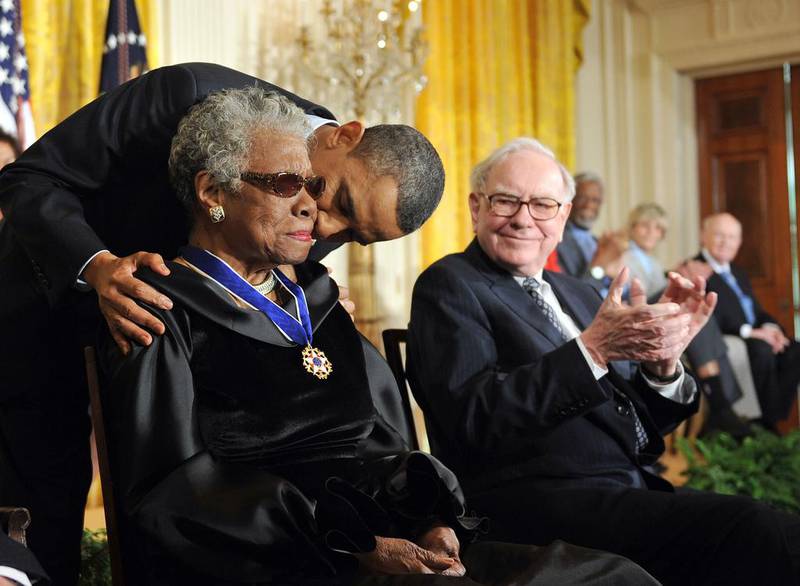 US president Barack Obama, centre, kisses Dr Maya Angelou, a prominent and celebrated author, poet, educator, producer, actress, filmmaker, and civil rights activist after presenting to her the 2010 Medal of Freedom at the White House in Washington, DC on February 15, 2011. Tim Sloan / AFP