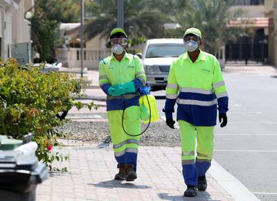Dubai, United Arab Emirates - Reporter: N/A: People disinfect bins in Jumeirah in response to the corona virus. Wednesday, March 25th, 2020. Dubai. Chris Whiteoak / The National