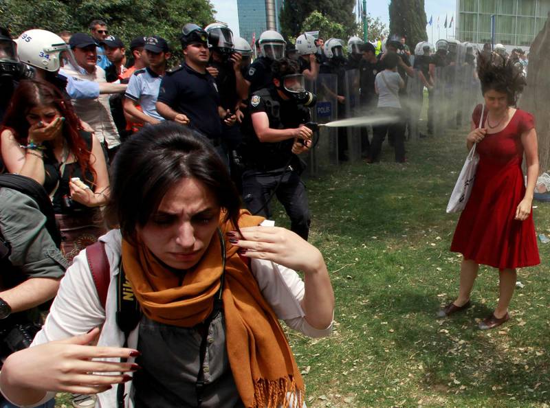A Turkish riot policeman uses tear gas as people protest against the destruction of trees in a park brought about by a pedestrian project, in Taksim Square, Istanbul, May 28, 2013. Picture taken May 28, 2013. REUTERS/Osman Orsal/File Photo   SEARCH "POY DECADE" FOR THIS STORY. SEARCH "REUTERS POY" FOR ALL BEST OF 2019 PACKAGES. TPX IMAGES OF THE DAY.