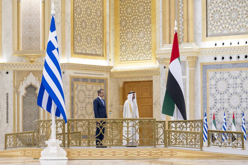 Sheikh Mohamed and Mr Mitsotakis stand for the national anthem during the reception at Qasr Al Watan.