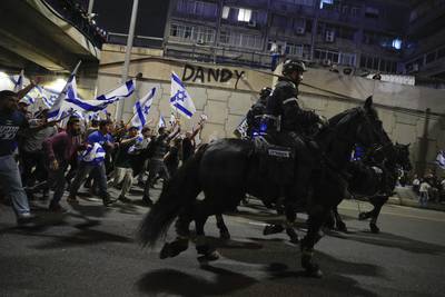 Israeli police disperse demonstrators blocking a road in Tel Aviv during a protest against plans by the government to overhaul the judicial system. AP