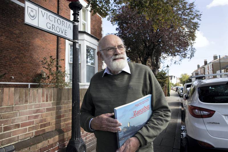PORTSMOUTH, UK. 24th September 2020. Local councillor Hugh Mason with one of his books on Zanzibar, in the street in Southsea, Portsmouth, where the former Sultan Of Zanzibar used to live. Stephen Lock for the National 