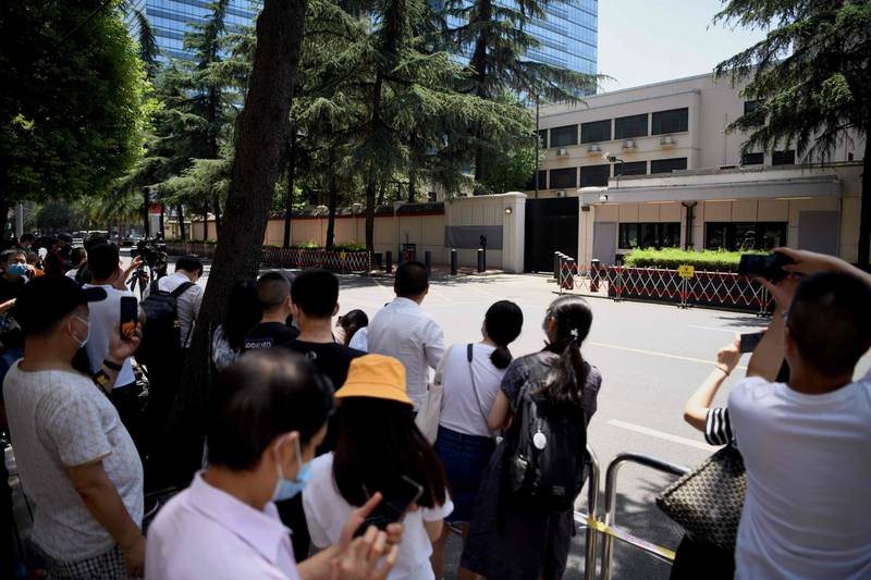 People look at the US Consulate in Chengdu, southwestern China's Sichuan province. Chinese authorities took over the United States consulate in Chengdu, the foreign ministry said, days after Beijing ordered it to close in retaliation for the shuttering of its mission in Houston. AFP