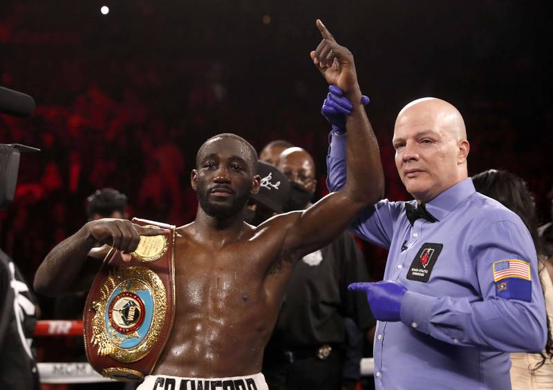 WBO champion Terence Crawford poses with referee Celestino Ruiz after defeating Shawn Porter. AFP