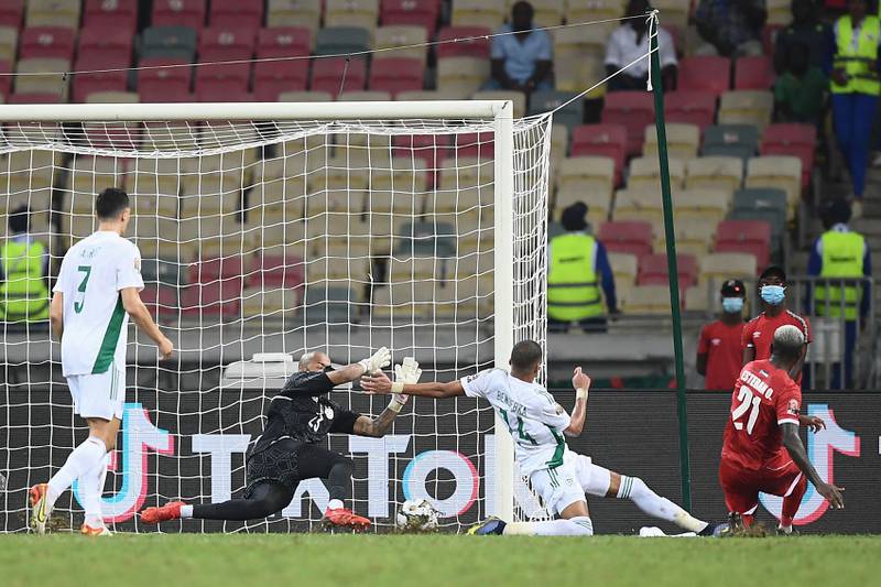 Equatorial Guinea'defender Esteban Obiang shoots and scores past Algeria goalkeeper Rais M'bolhi. AFP